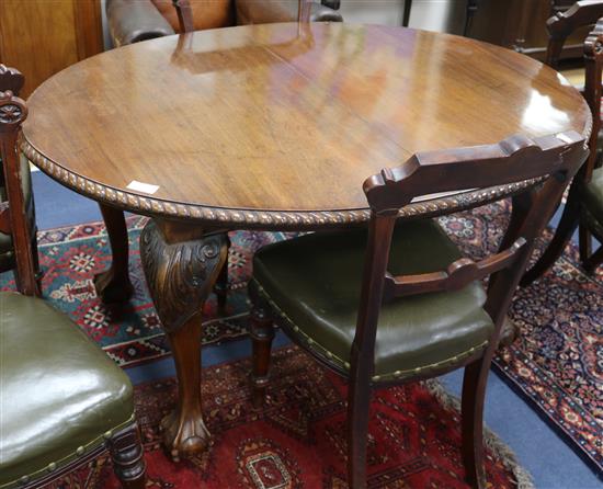 A 1930s Chippendale style mahogany extending dining table, with one spare leaf W.135cm without leaf